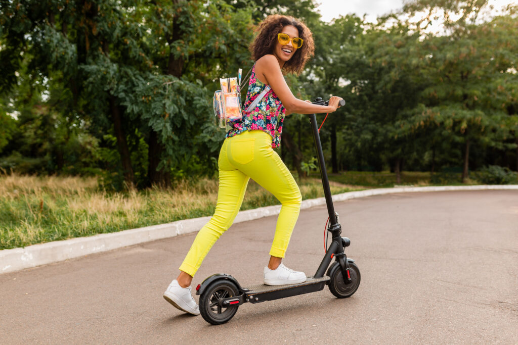Young Black Woman riding on an electric scooter